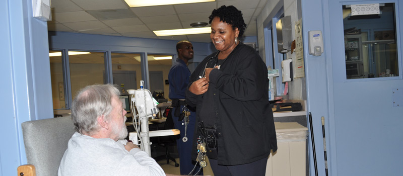 A BOP employee administering care to a federal inmate.