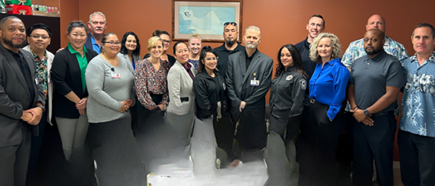 Group of individuals posing for a photo in a room