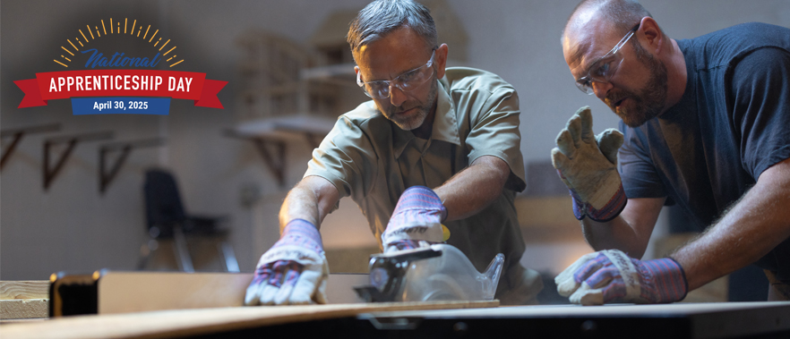 Two people at a wood cutting station working on a project